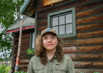 High school intern Killian Layman poses in front of The Folk School.