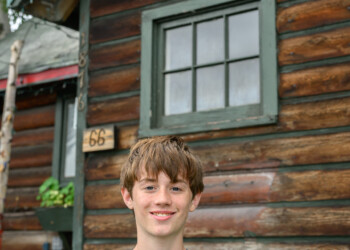 High school intern Kyle Sunderland poses in front of The Folk School.