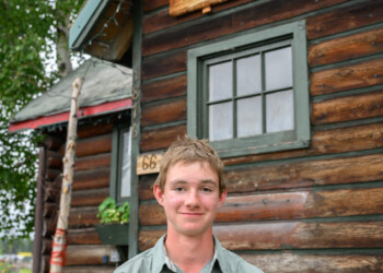 High school intern Clint Wright poses in front of The Folk School.