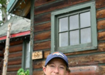 High school intern Mason Asay Macdonald n poses in front of The Folk School.