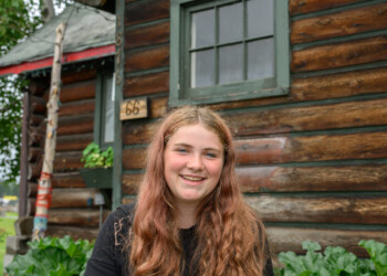 High school intern Kathryn Ames poses in front of The Folk School.