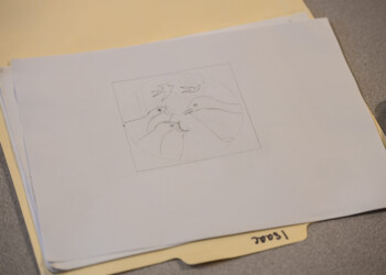 High school interns sketch their design ideas on paper before transferring them to wood cookies.